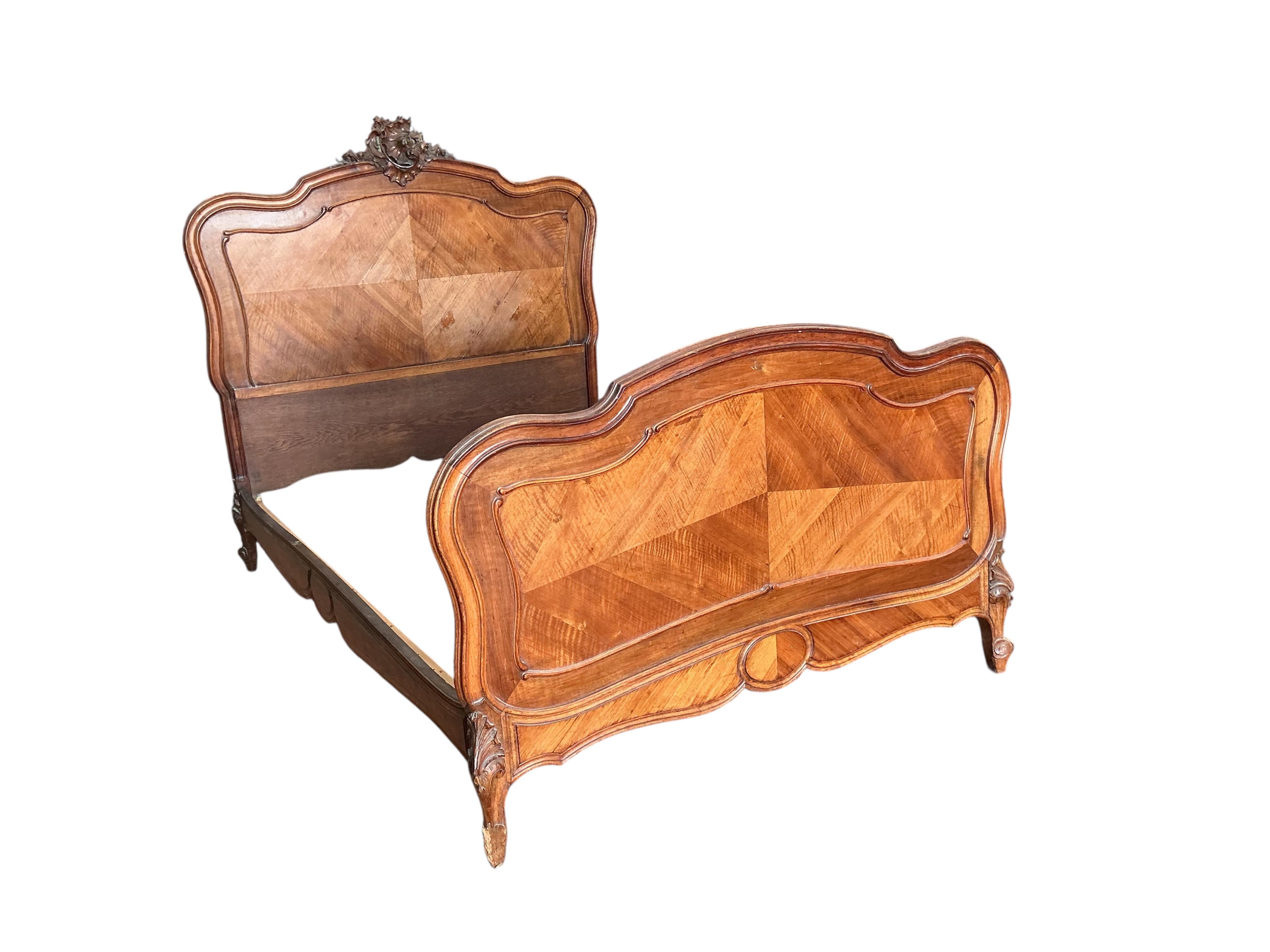 An early 20th century French carved walnut bedframe, length 200cm, width 144cm, height 150cm